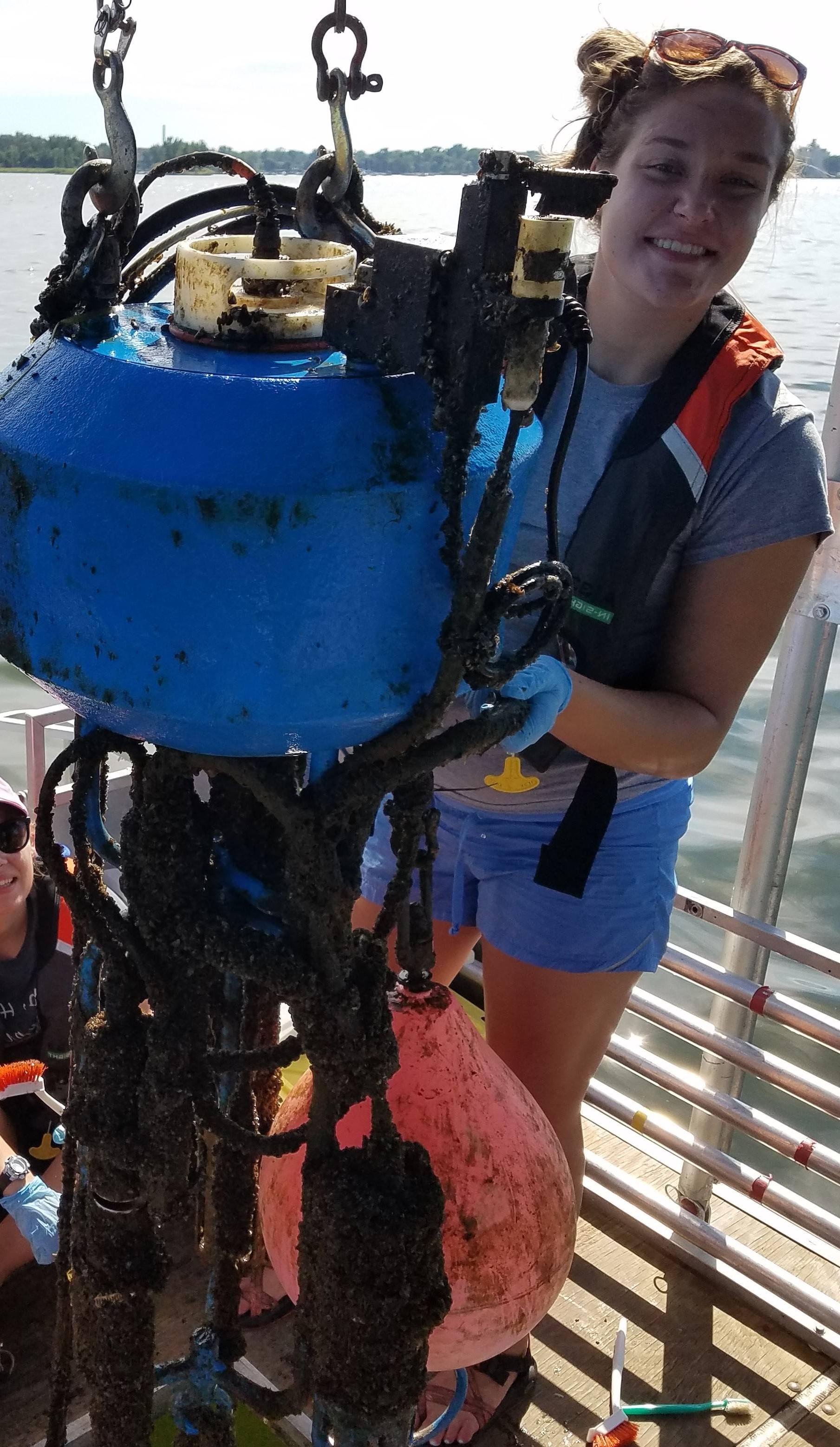 Macy Doster holding subsurface buoy sensors